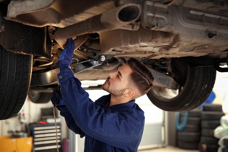 A service expert working on a vehicle